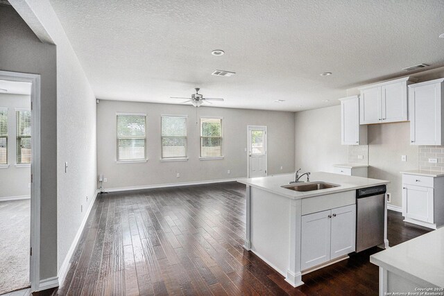 12448 Big Valley Crk, San Antonio, TX 78254 - kitchen with stainless steel dishwasher, a ceiling fan, visible vents, a sink, and dark wood finished floors