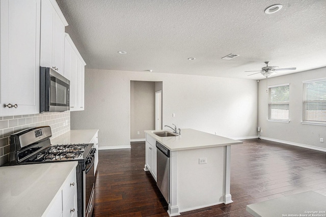12448 Big Valley Crk, San Antonio, TX 78254 - kitchen with a sink, dark wood-style flooring, a textured ceiling, and stainless steel appliances