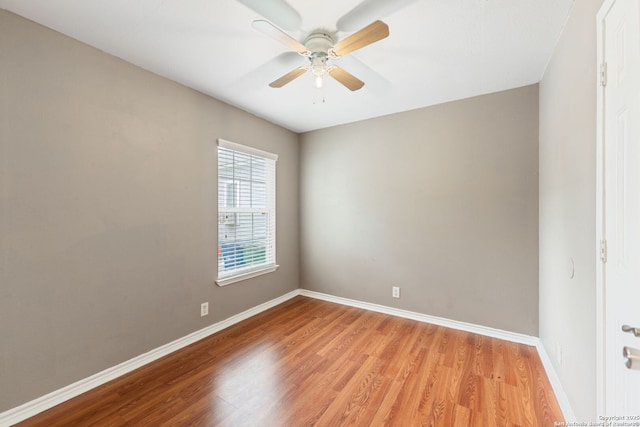 unfurnished room with baseboards, ceiling fan, and light wood-style flooring
