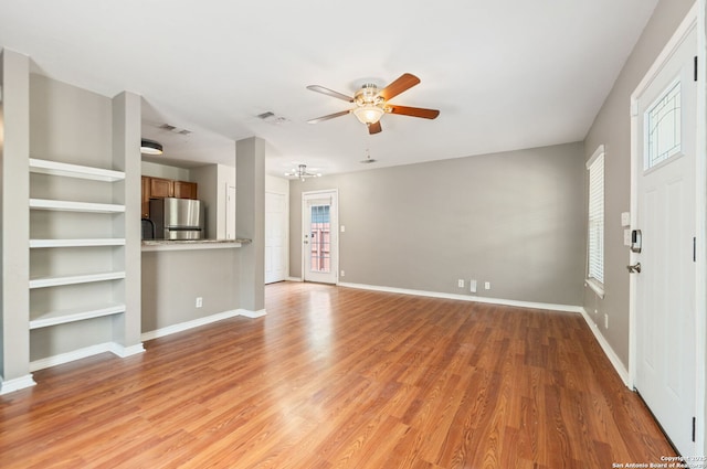 unfurnished living room featuring ceiling fan, light wood-style flooring, and visible vents