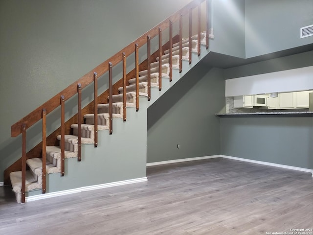 4107 Medical Unit 1204, San Antonio, TX 78229 - staircase with baseboards, wood finished floors, and visible vents