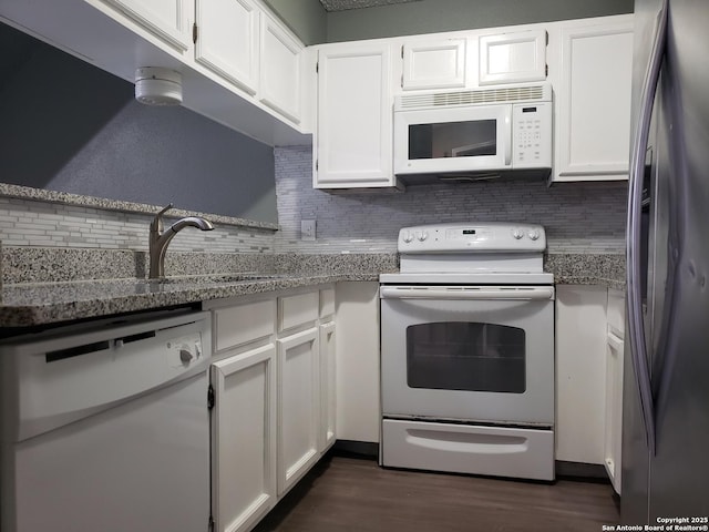 4107 Medical Unit 1204, San Antonio, TX 78229 - kitchen with decorative backsplash, dark wood-style flooring, white appliances, white cabinetry, and a sink