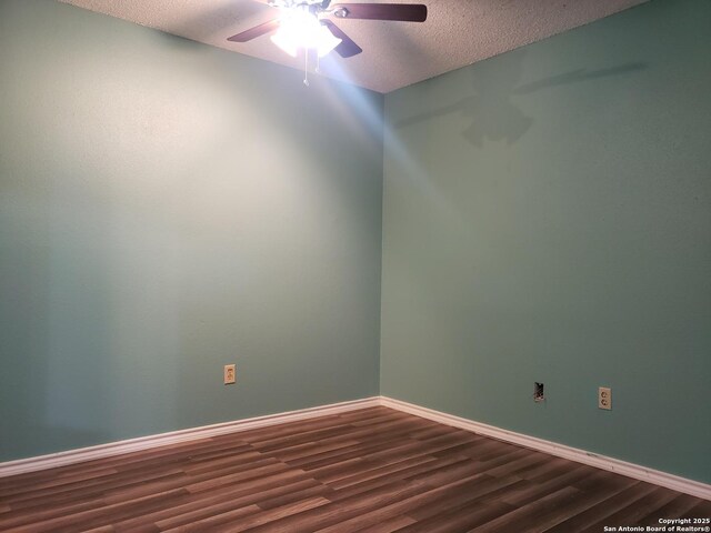 4107 Medical Unit 1204, San Antonio, TX 78229 - unfurnished room with a textured ceiling, ceiling fan, baseboards, and dark wood-type flooring