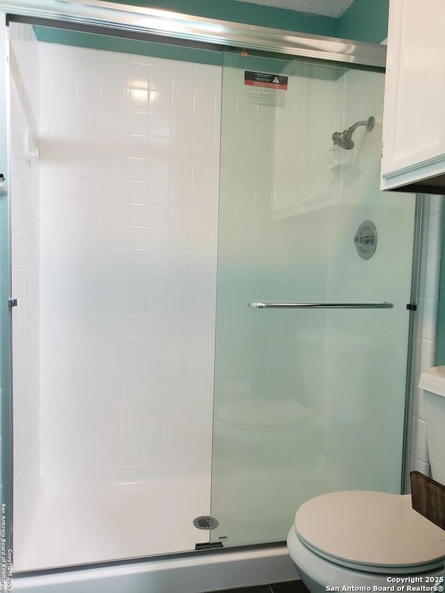 4107 Medical Unit 1204, San Antonio, TX 78229 - bathroom featuring a stall shower and toilet