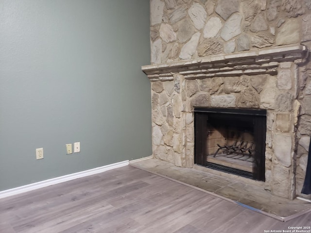 4107 Medical Unit 1204, San Antonio, TX 78229 - room details with baseboards, a fireplace with raised hearth, and wood finished floors