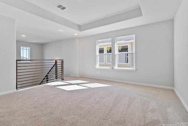 empty room with baseboards, carpet, recessed lighting, and visible vents