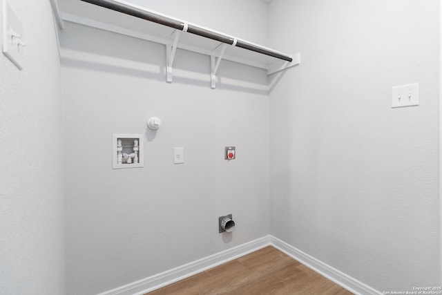 laundry area featuring laundry area, washer hookup, gas dryer hookup, baseboards, and wood finished floors