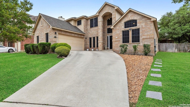 view of front facade with brick siding, a garage, a front yard, and concrete driveway