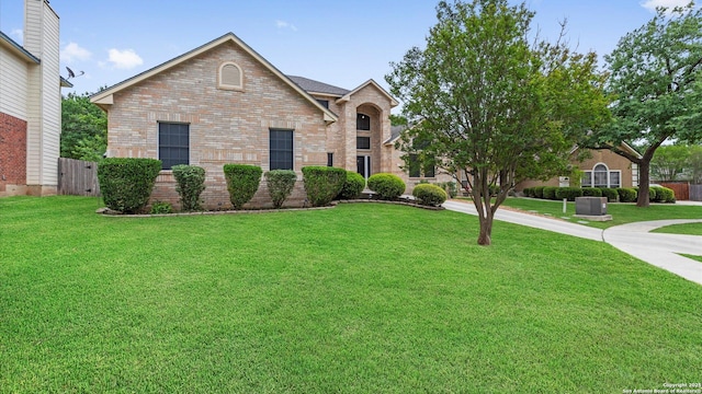 view of front of property with brick siding and a front yard