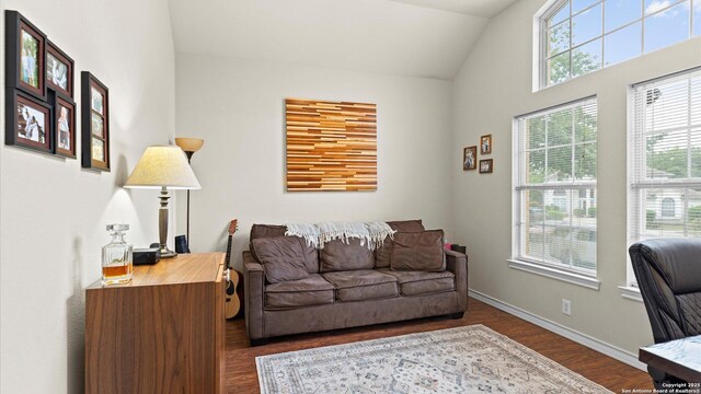 home office featuring baseboards, lofted ceiling, and dark wood-style floors
