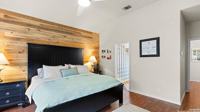 bedroom featuring baseboards, visible vents, dark wood finished floors, and lofted ceiling