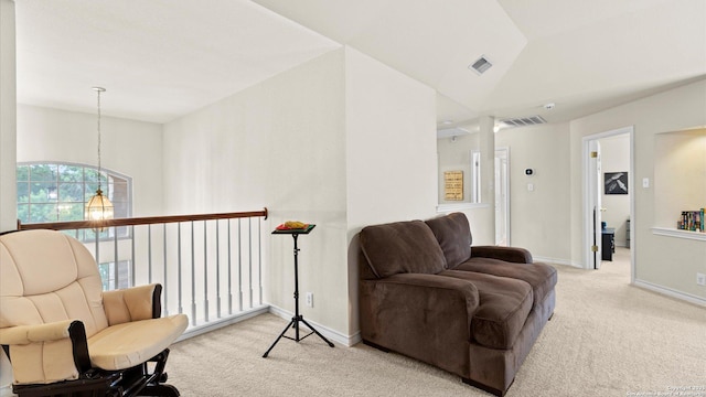 living area with carpet floors, baseboards, lofted ceiling, and visible vents