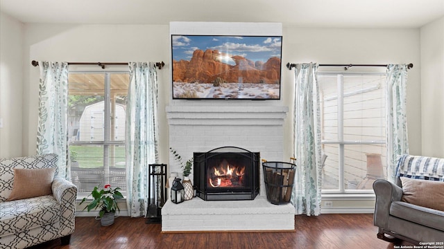 interior space with baseboards, wood finished floors, and a fireplace