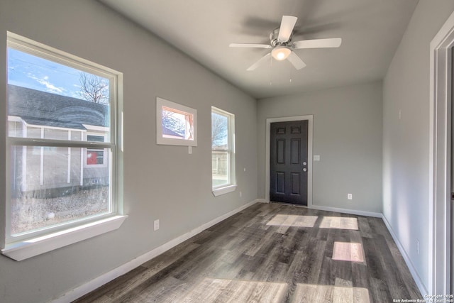 entrance foyer featuring dark wood-type flooring, baseboards, and ceiling fan