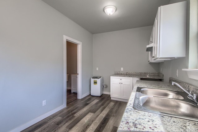 kitchen featuring baseboards, a sink, white cabinetry, and dark wood-style flooring