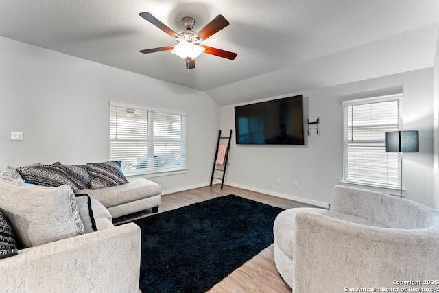living room with vaulted ceiling, baseboards, a ceiling fan, and wood finished floors