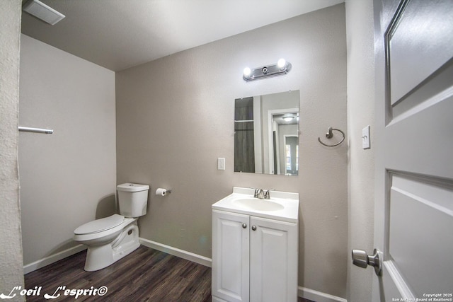 full bathroom with vanity, visible vents, wood finished floors, toilet, and baseboards