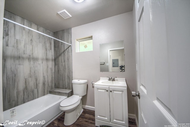 bathroom with vanity, toilet, tub / shower combination, wood finished floors, and visible vents