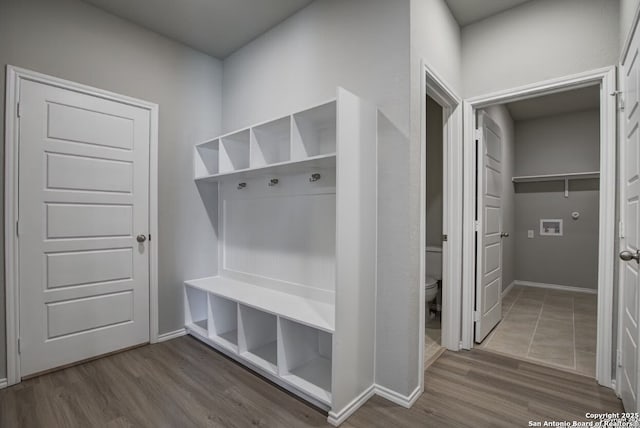 mudroom featuring baseboards and wood finished floors