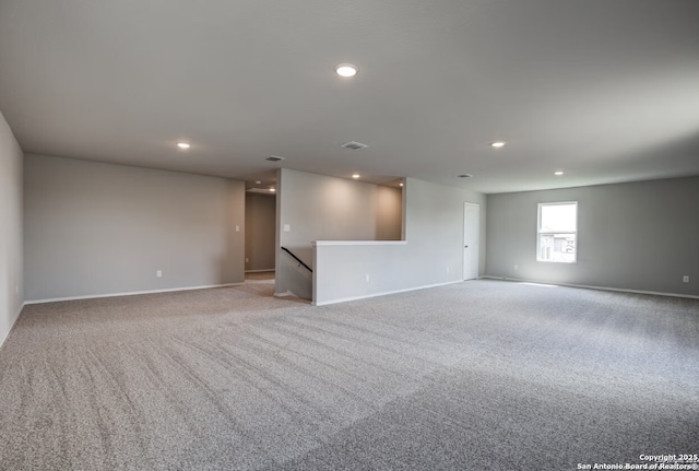 empty room with baseboards, light carpet, and recessed lighting