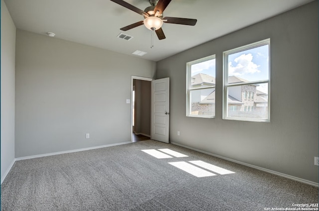 unfurnished bedroom featuring baseboards, carpet flooring, and visible vents
