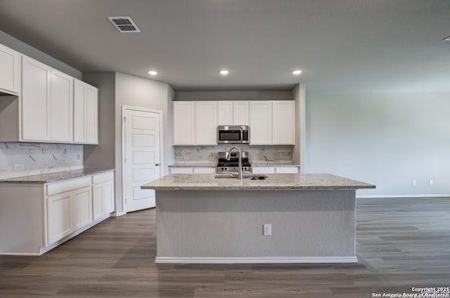 kitchen featuring tasteful backsplash, stainless steel appliances, recessed lighting, and visible vents