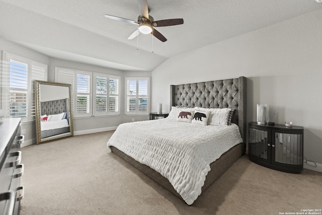 carpeted bedroom with baseboards, ceiling fan, and lofted ceiling