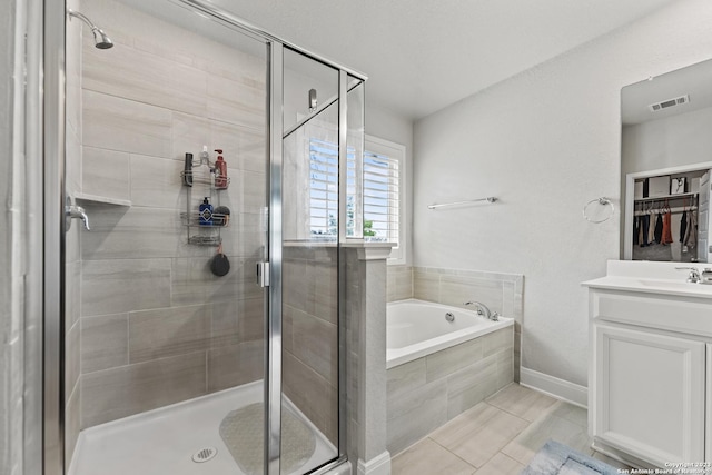 full bath with visible vents, a garden tub, and a shower stall