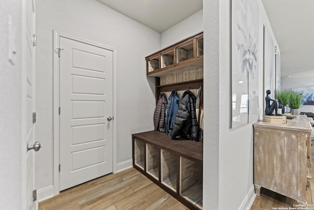 mudroom featuring baseboards and light wood-style flooring