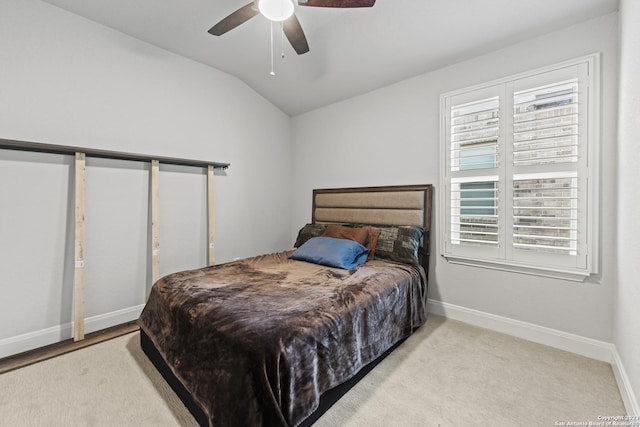 bedroom featuring baseboards, ceiling fan, and lofted ceiling