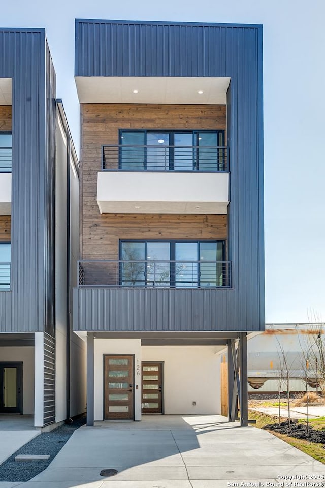 modern home with a balcony and a garage