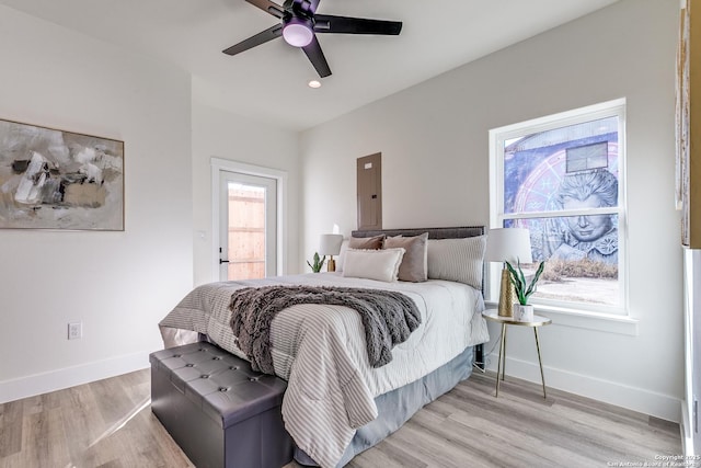 bedroom with electric panel, a ceiling fan, baseboards, light wood-style floors, and recessed lighting
