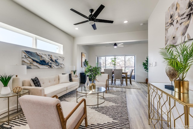 living room featuring recessed lighting, a ceiling fan, baseboards, and wood finished floors
