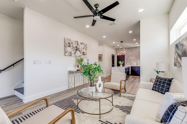 living area with visible vents, recessed lighting, ceiling fan, and light wood-type flooring