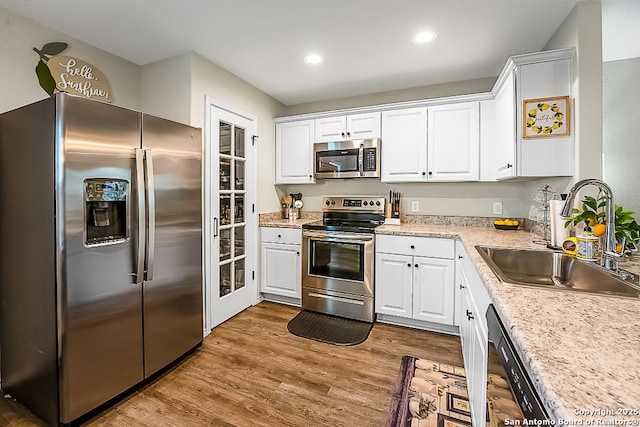7603 Capstone, San Antonio, TX 78244 - kitchen with white cabinets, stainless steel appliances, recessed lighting, and a sink