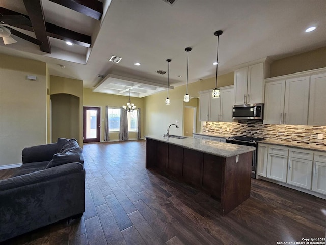 kitchen with open floor plan, recessed lighting, a sink, coffered ceiling, and appliances with stainless steel finishes