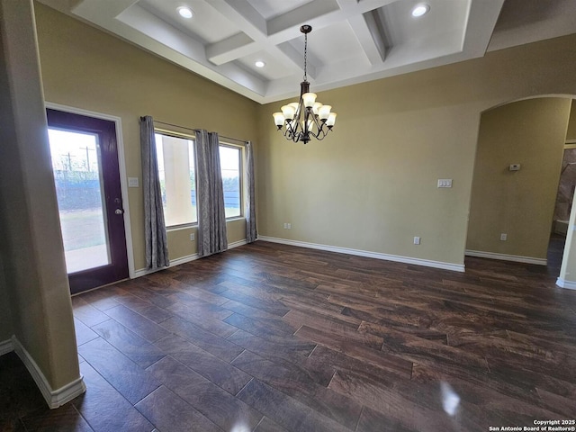 unfurnished room with arched walkways, baseboards, a chandelier, and coffered ceiling