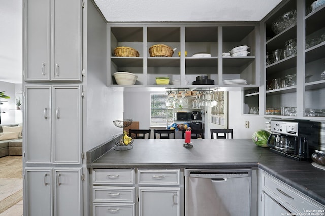 kitchen featuring stainless steel dishwasher, a peninsula, open shelves, and dark countertops