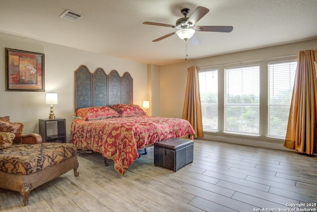 bedroom featuring visible vents, ceiling fan, and light wood-type flooring