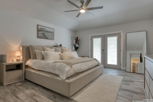 bedroom featuring a ceiling fan, access to exterior, french doors, and light wood-type flooring