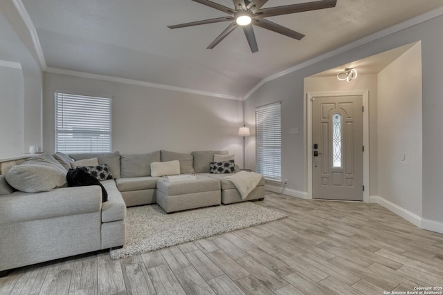 living room with a ceiling fan, wood finished floors, baseboards, lofted ceiling, and ornamental molding