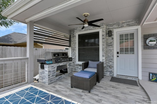 view of patio with fence, ceiling fan, and area for grilling