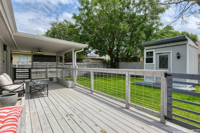 wooden terrace with fence private yard, an outdoor structure, and a yard