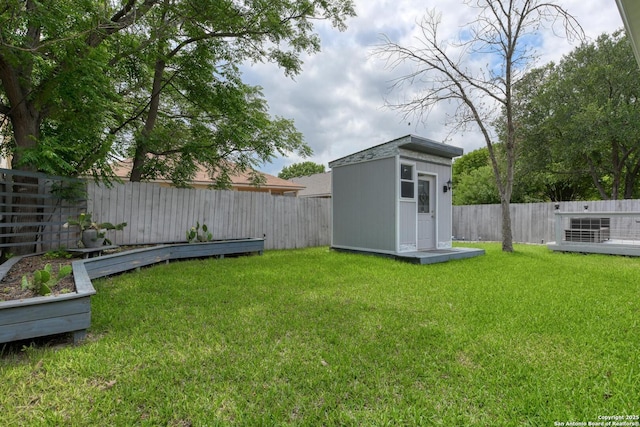 view of yard with a fenced backyard, an outdoor structure, and a shed