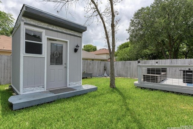 view of shed with a fenced backyard and central AC