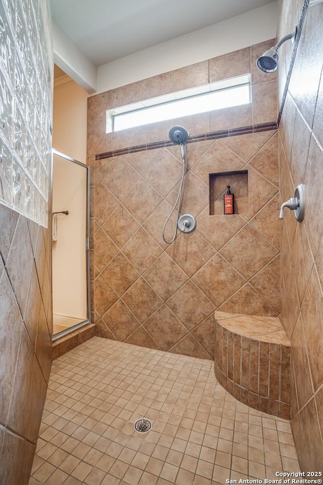 full bath with a tile shower