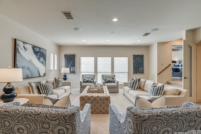 living area with baseboards, light colored carpet, recessed lighting, and visible vents