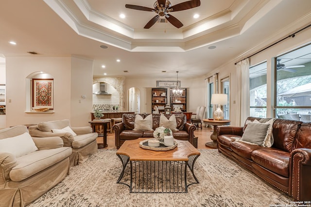 living area with a ceiling fan, recessed lighting, and ornamental molding