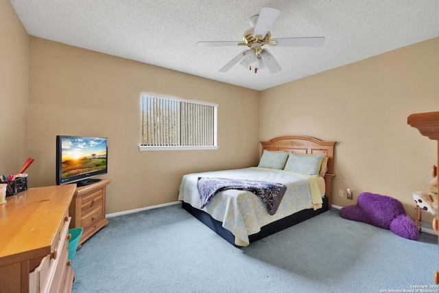 bedroom featuring baseboards, ceiling fan, carpet, and a textured ceiling