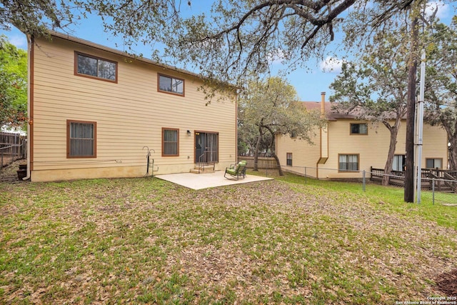 back of property with a lawn, a patio, and a fenced backyard